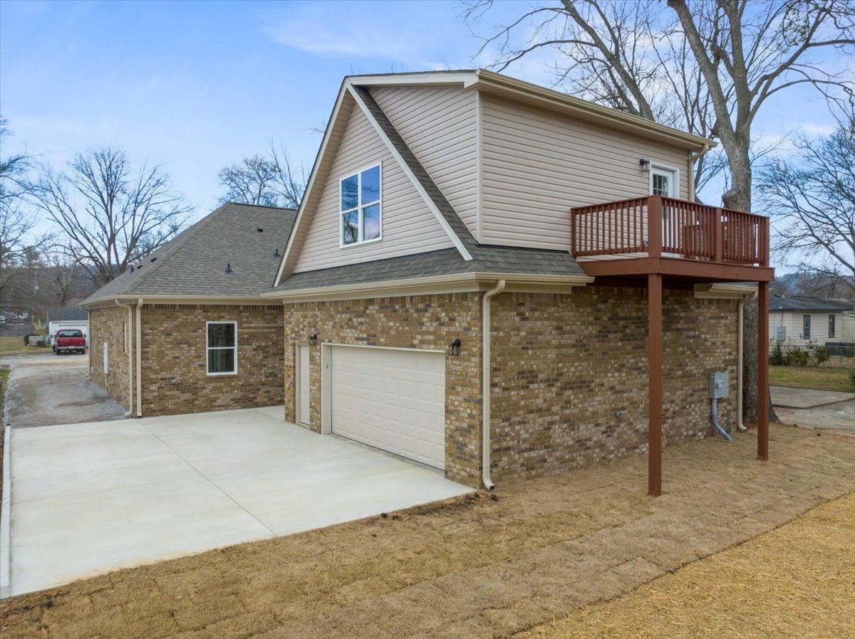 a house with a garage and a deck on top of it .