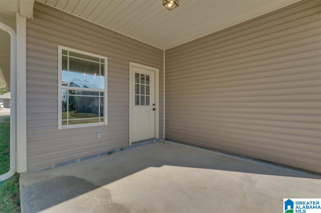 a porch with a window and a door in a house for sale