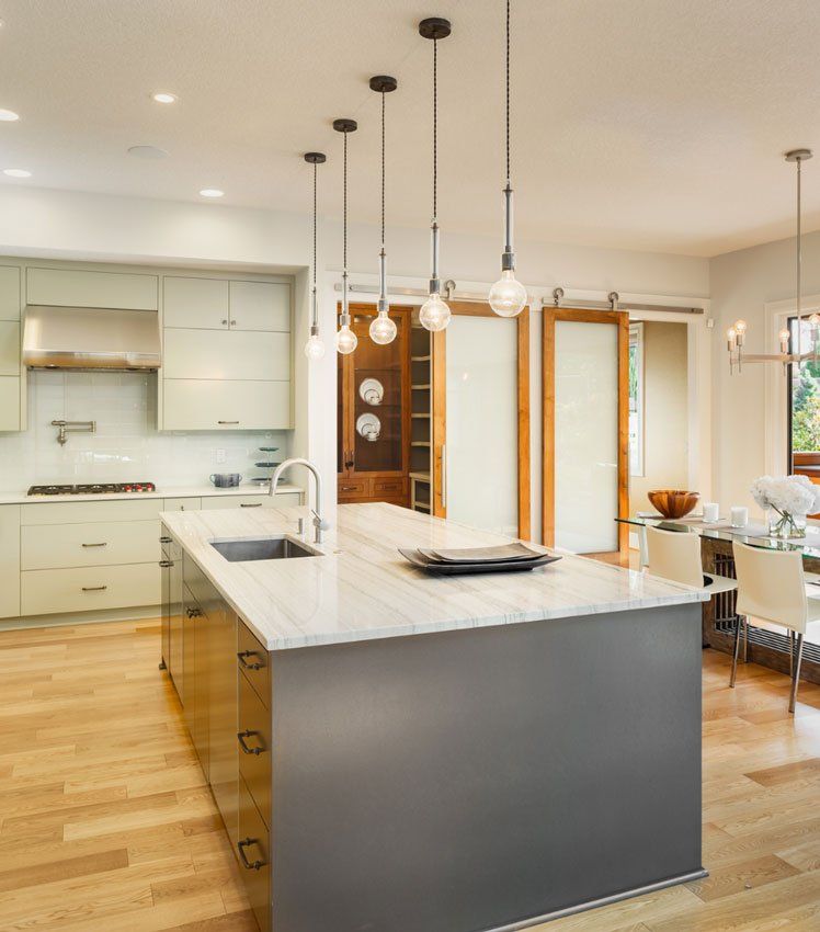 A kitchen with a large island and a sink