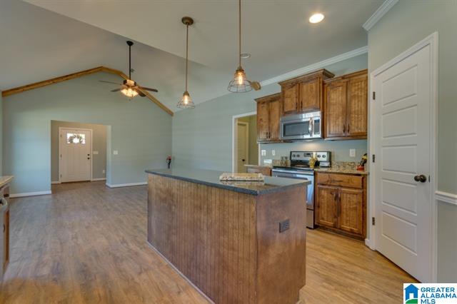 a kitchen with stainless steel appliances and wooden cabinets