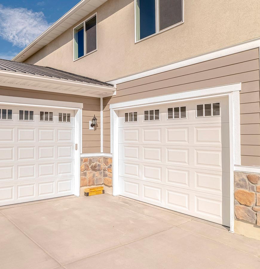 there are two garage doors on the side of a house .