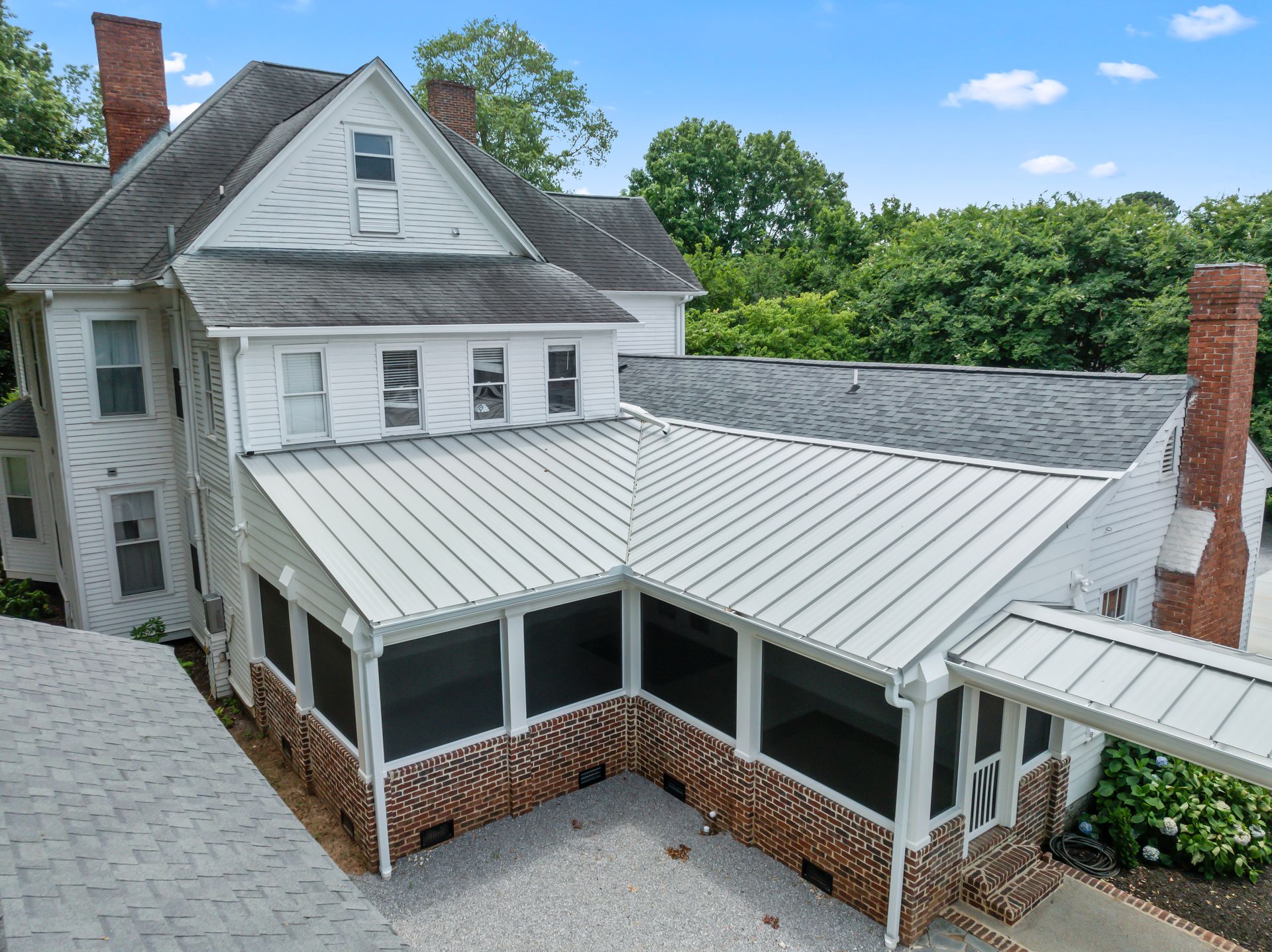 An aerial view of a house with a screened in porch