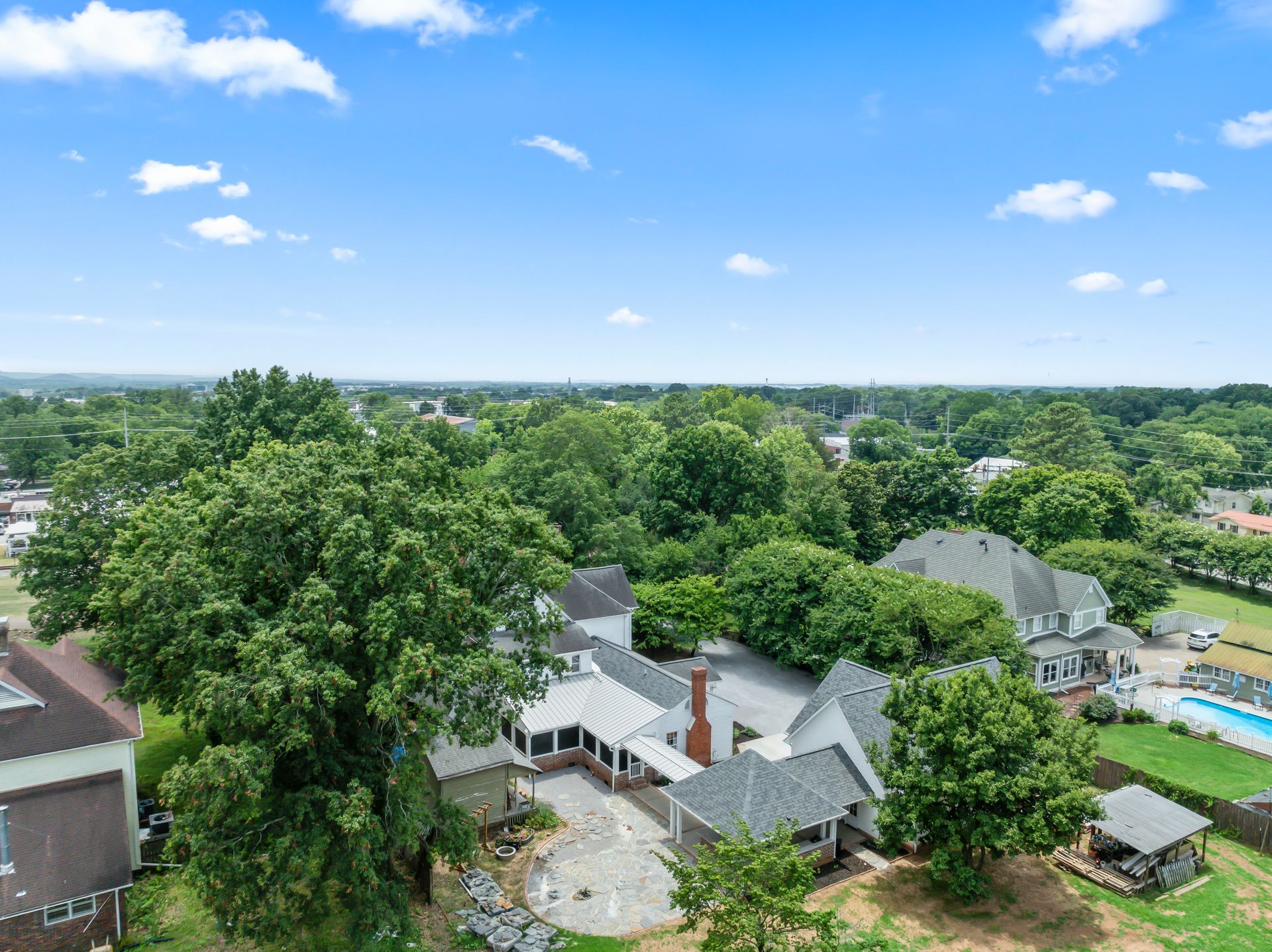An aerial view of a large house surrounded by trees.