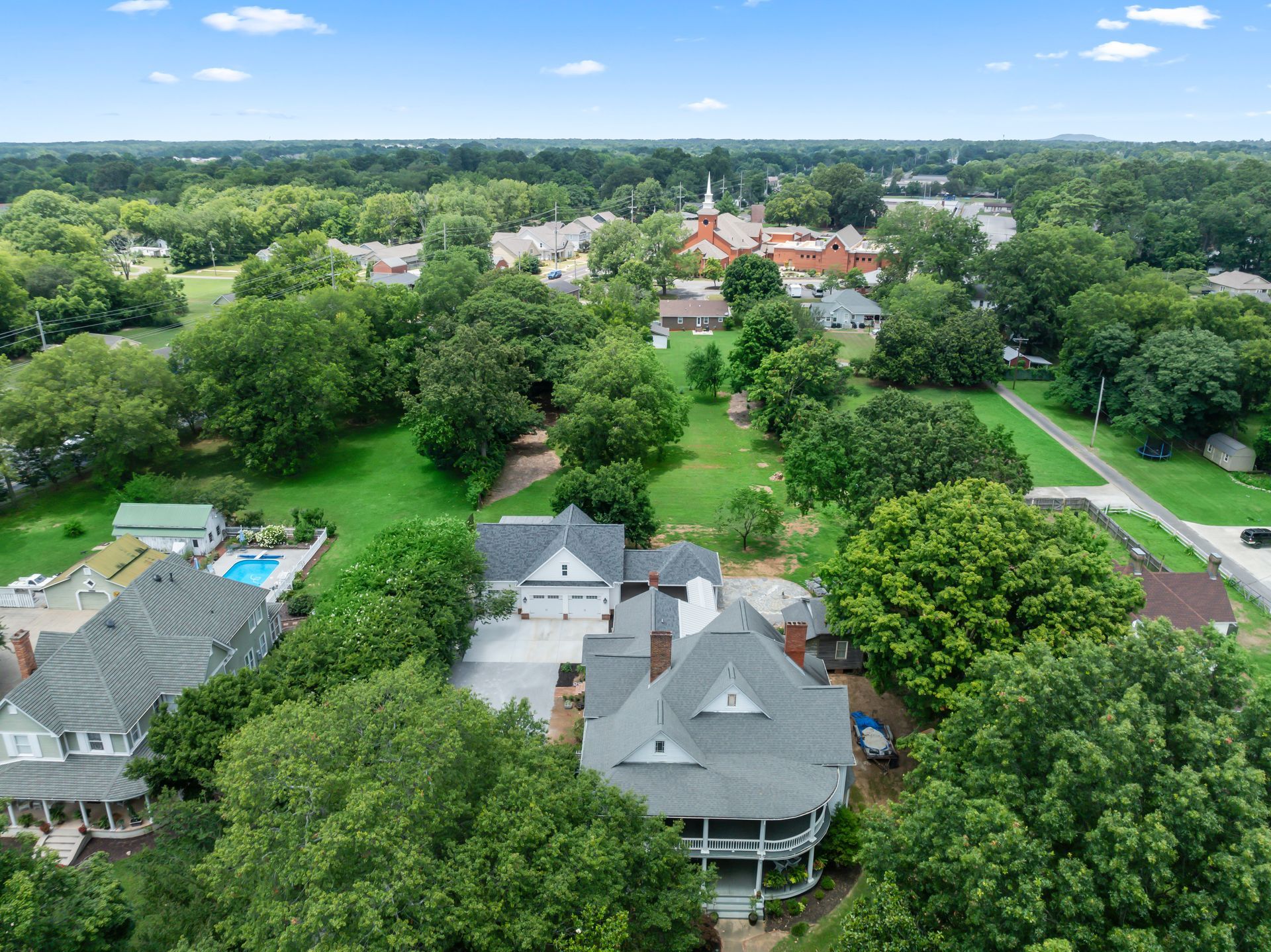 An aerial view of a large house surrounded by trees
