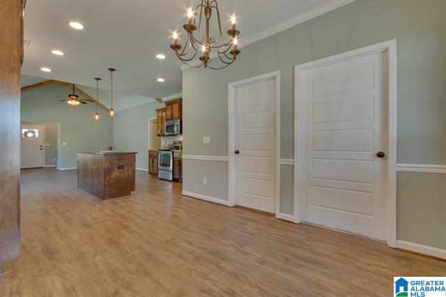 a living room with hardwood floors and a chandelier .