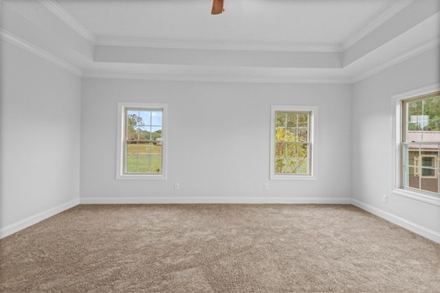 An empty bedroom with two windows and a ceiling fan. By Mims custom home construction