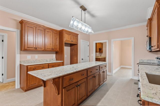 A kitchen with wooden cabinets and granite counter tops By Mims custom home construction