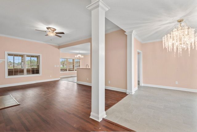 There is a ceiling fan in the living room and a chandelier in the dining room. By Mims custom home construction