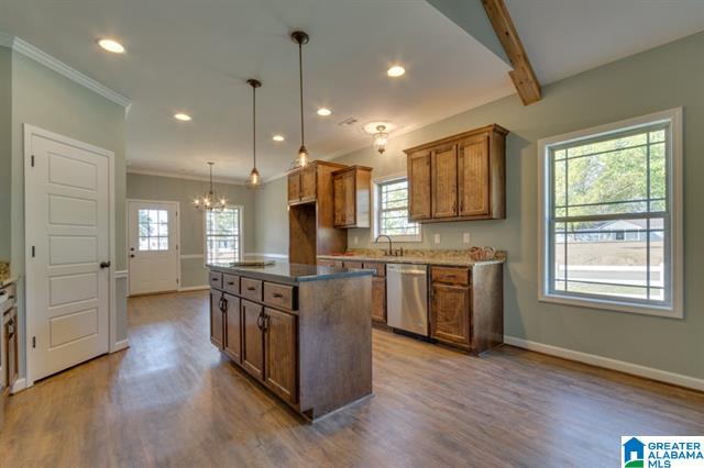 a kitchen with a large island and stainless steel appliances