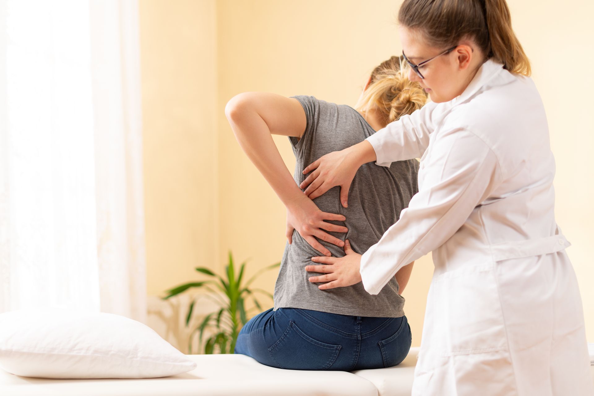 A skilled chiropractor performs a spinal adjustment to relieve back pain for a patient.