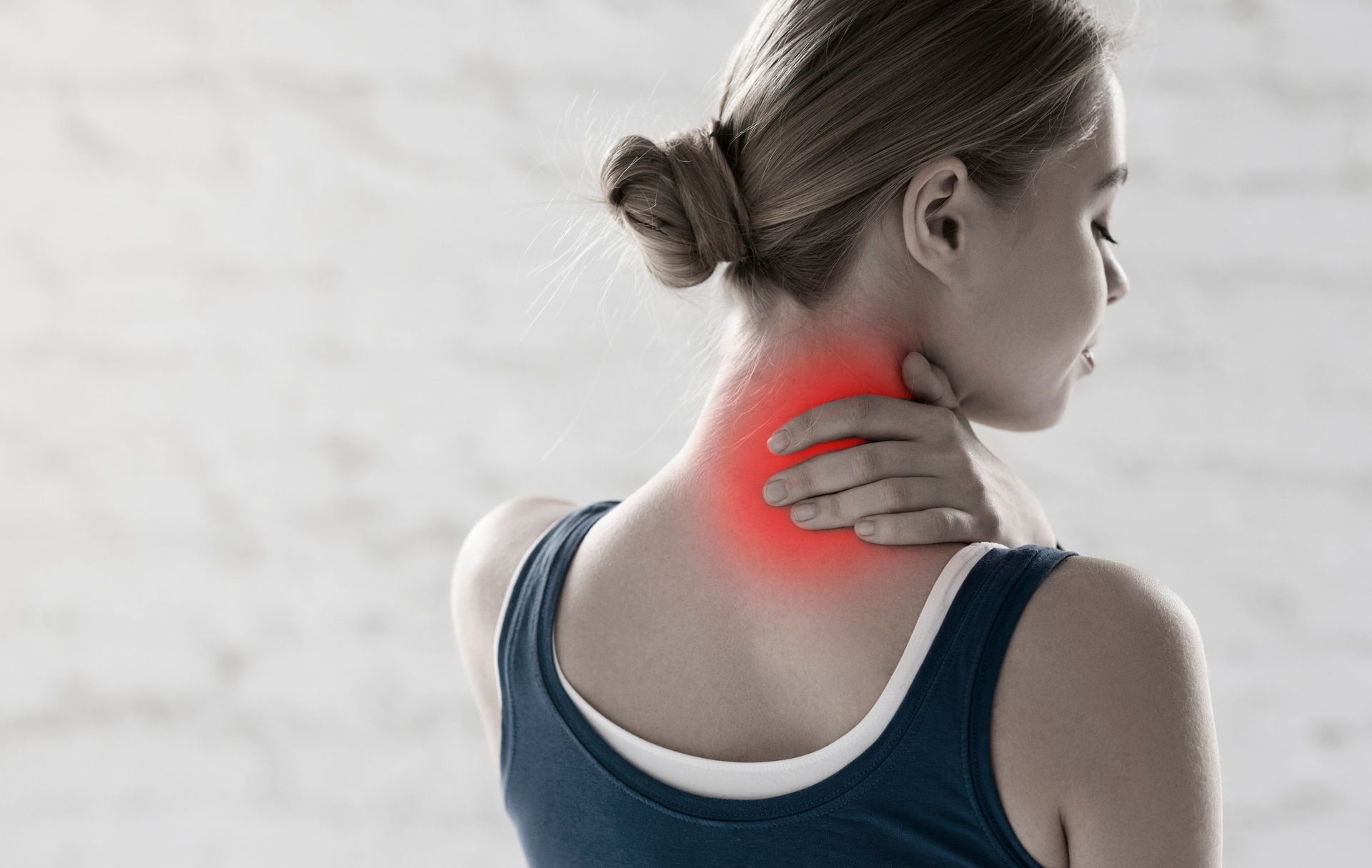 Professional sportswoman feeling pain in her neck in a gym. Professional sportswoman feeling pain in her neck in a gym.