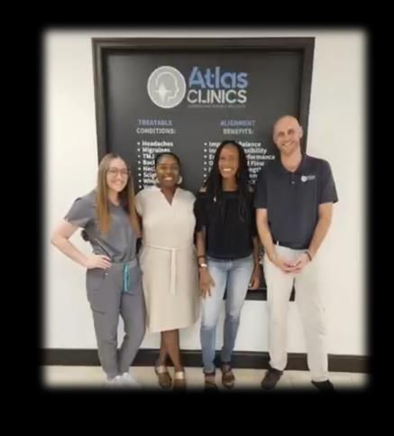 Four people stand in front of an Four people stand in front of an