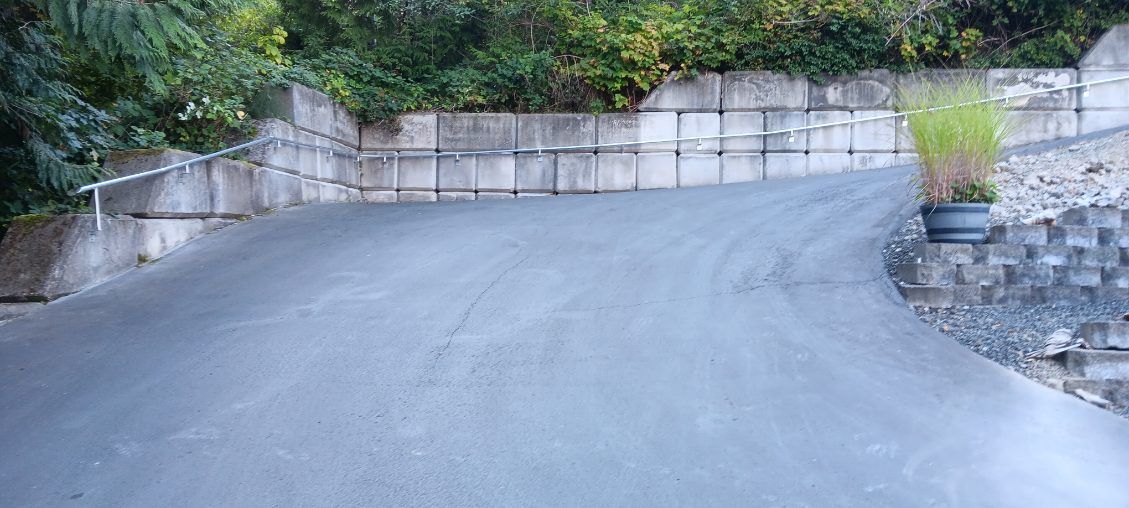 There is a brick wall on the side of the road.