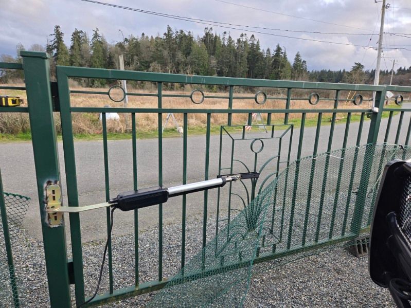 A green gate with a motor attached to it
