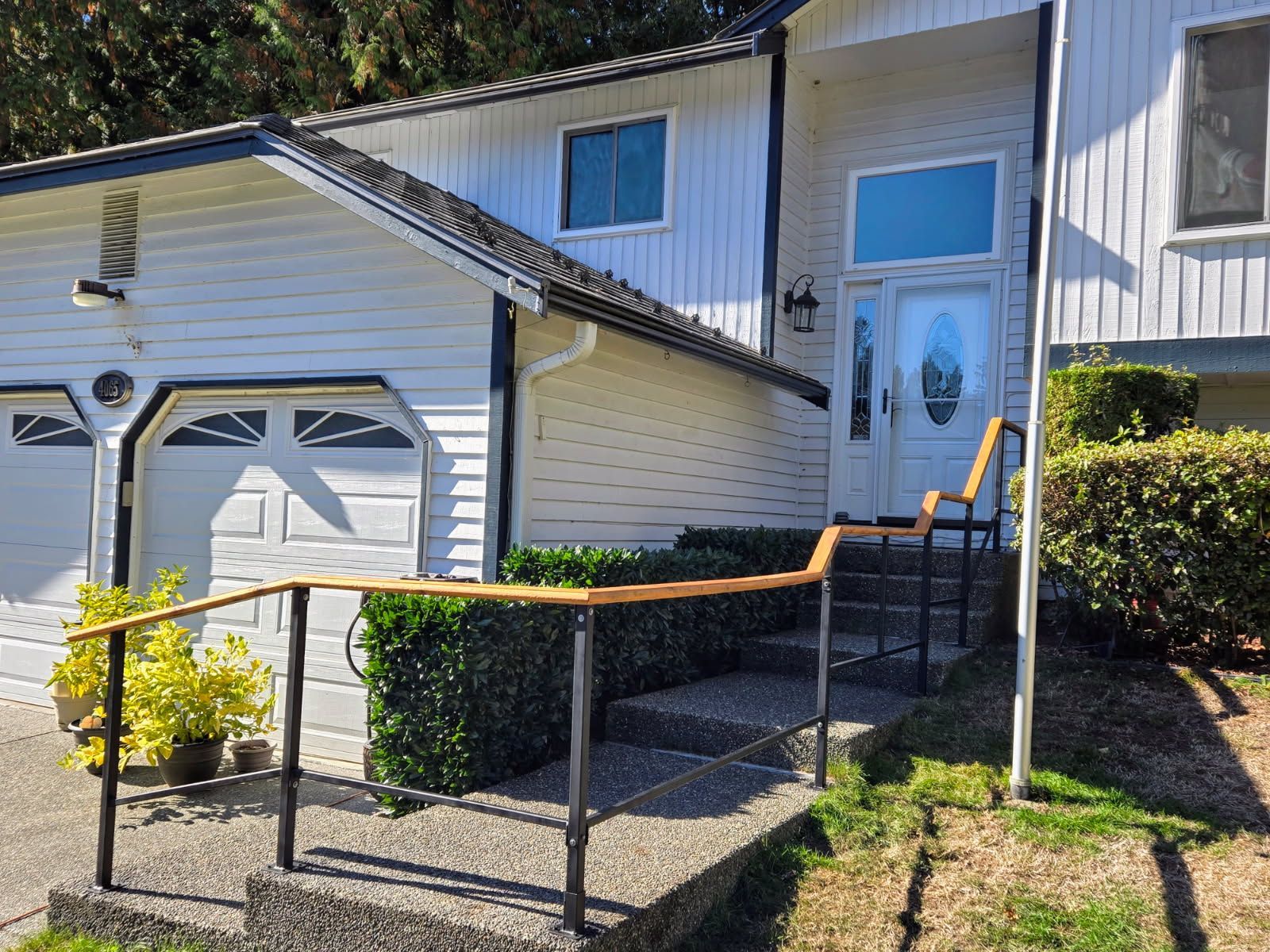 A white house with stairs leading up to the front door.