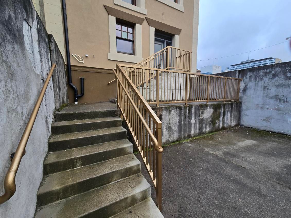A set of stairs leading up to a building with a railing.