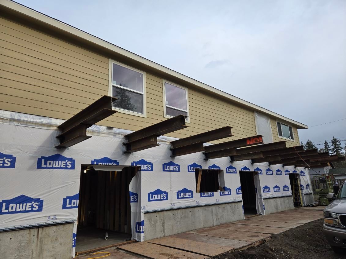 A house that is being built with lowe 's on the side