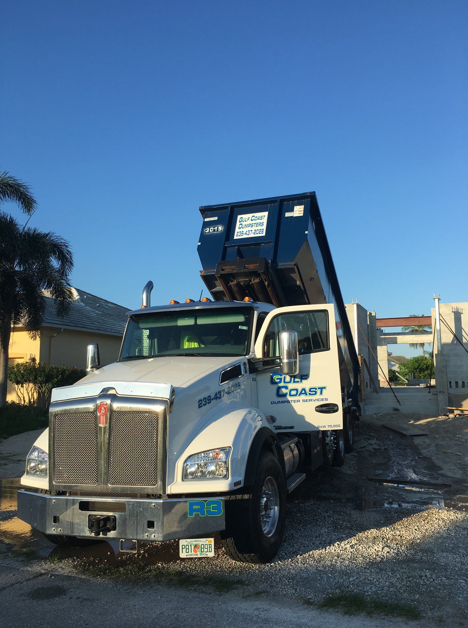 Truck with Blue Container — Naples, FL — Gulf Coast Dumpster Services
