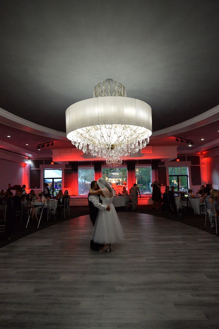 A waitress is serving a cake to a group of people at a wedding reception.