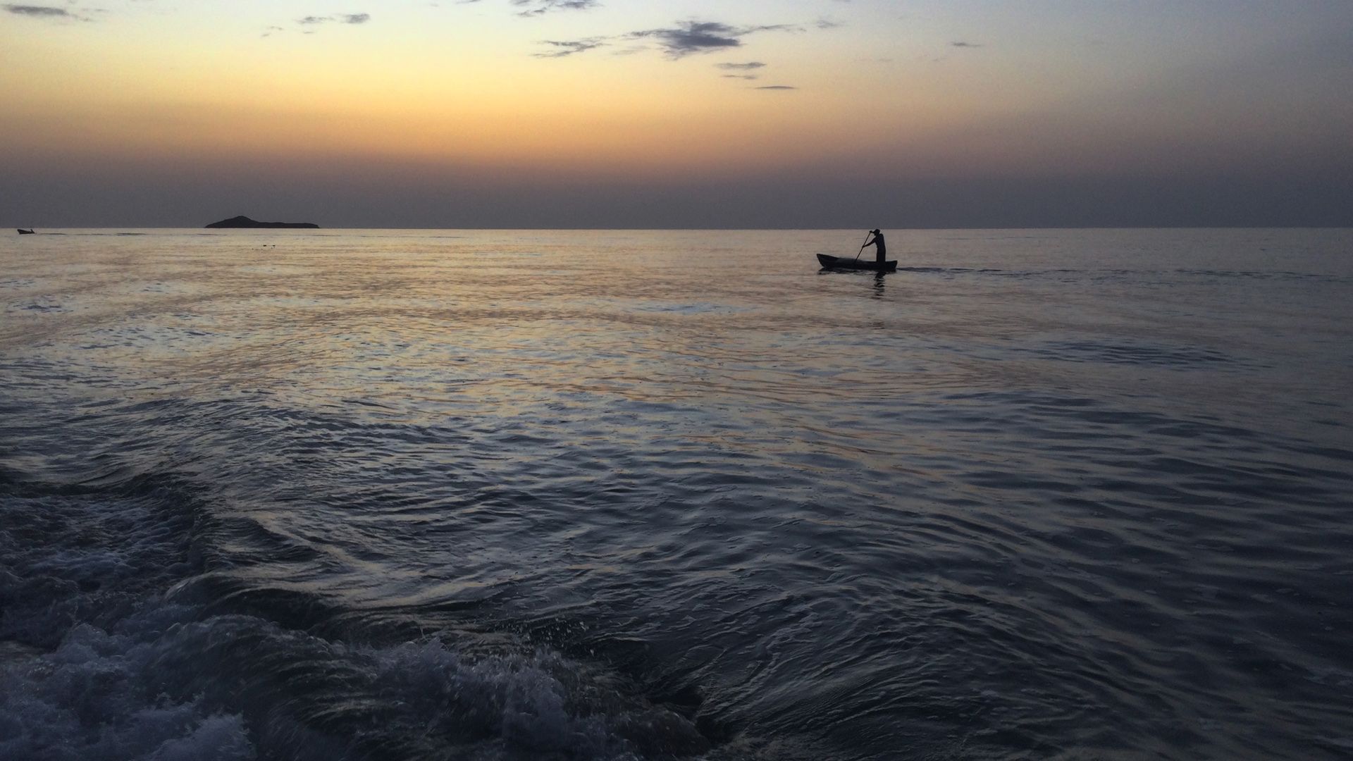 A black and white photo of a pier in the fog.