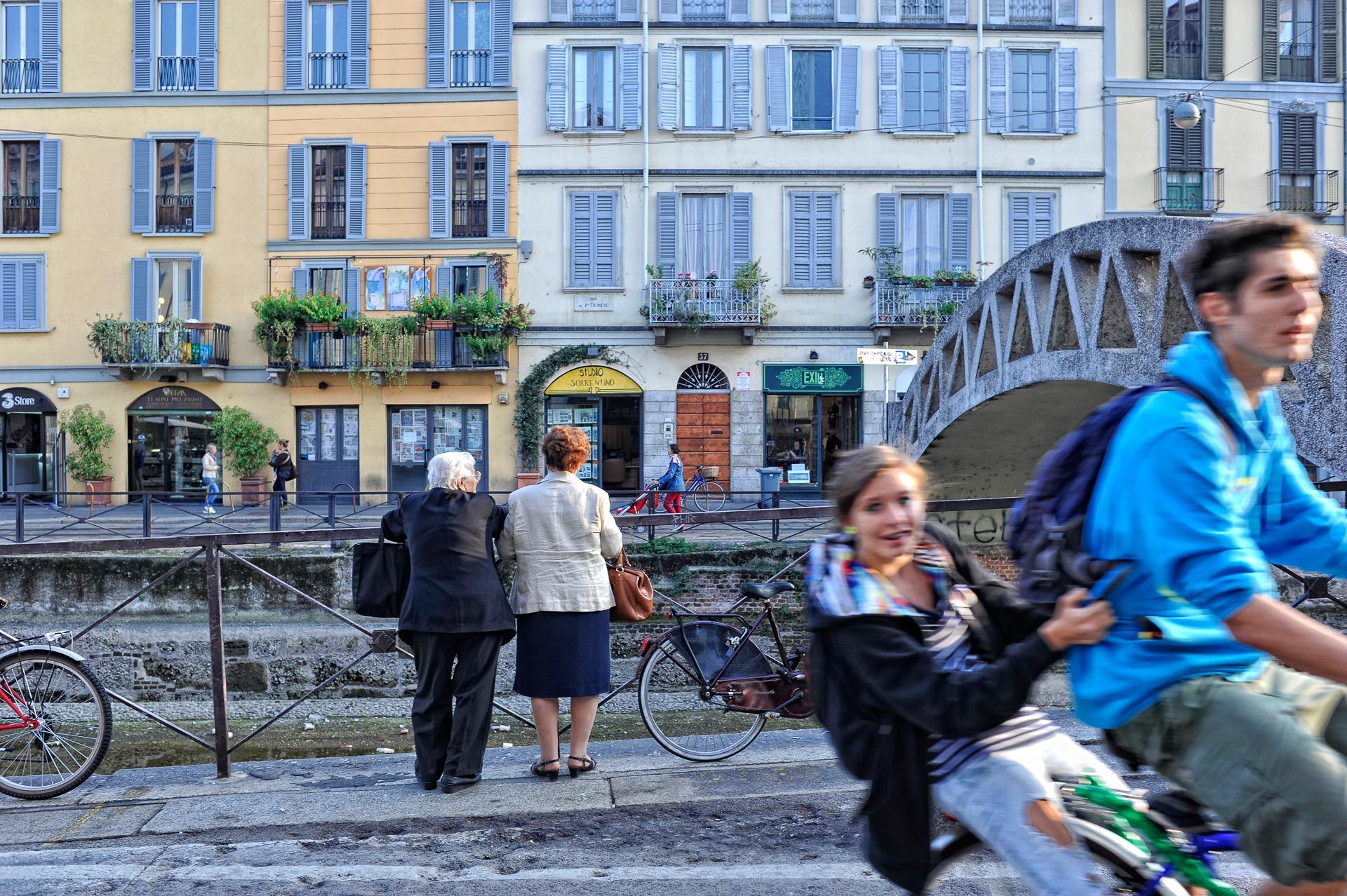 A man riding a scooter with a girl on the back