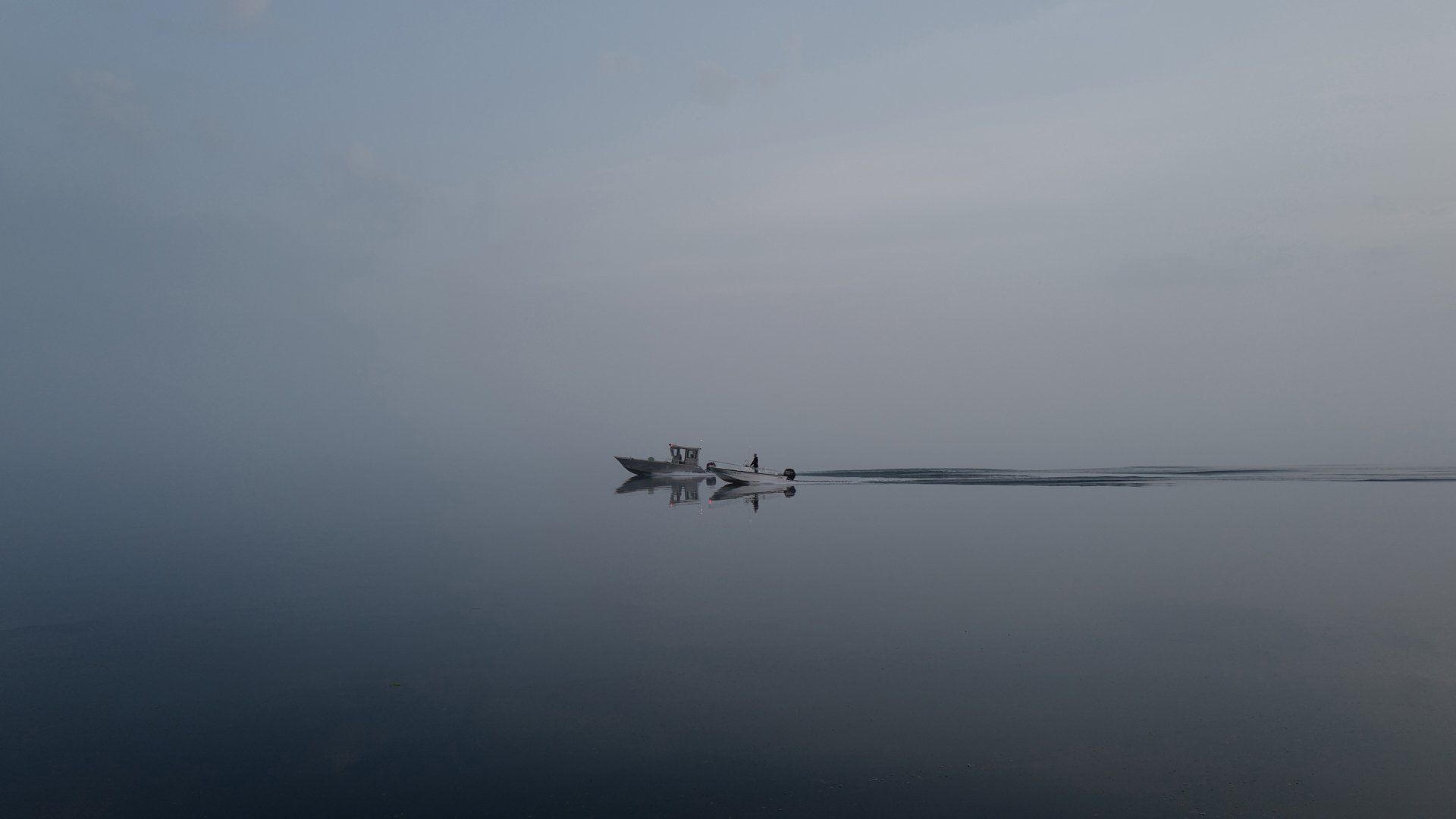 A boat is floating on top of a body of water.