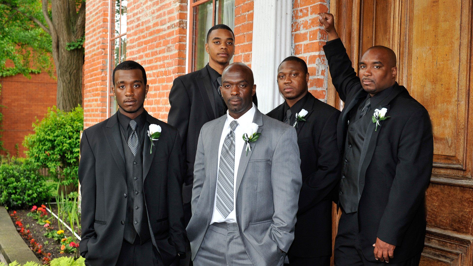 A group of men in suits are posing for a picture