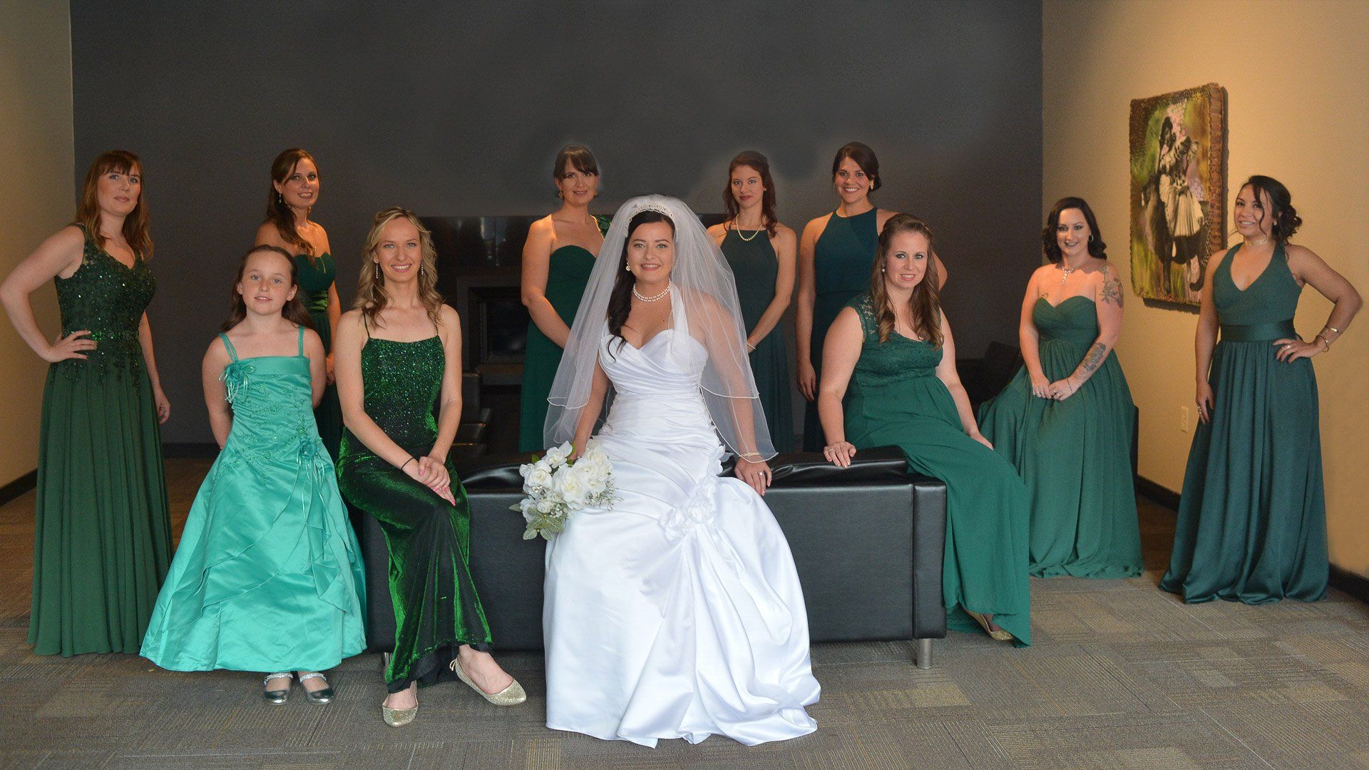 A bride and her bridesmaids are posing for a picture