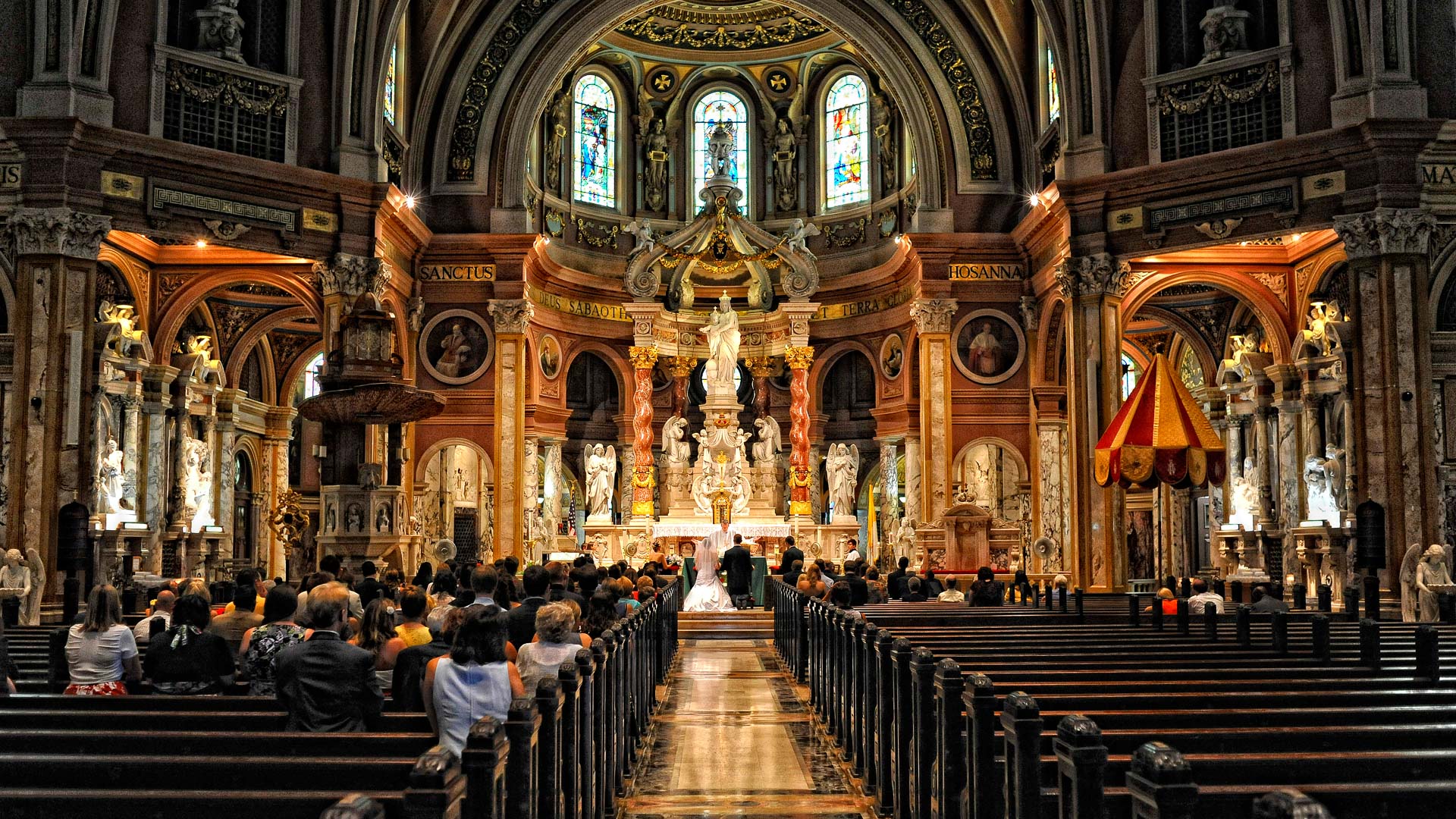 The inside of a church with people sitting in the pews.