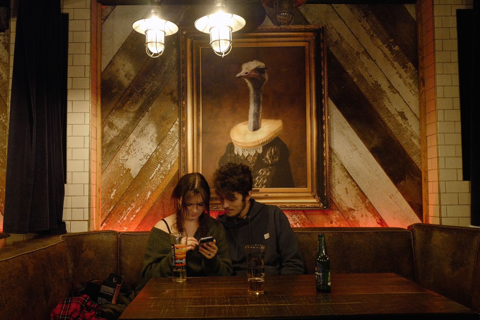 People are riding a ferris wheel under a bridge