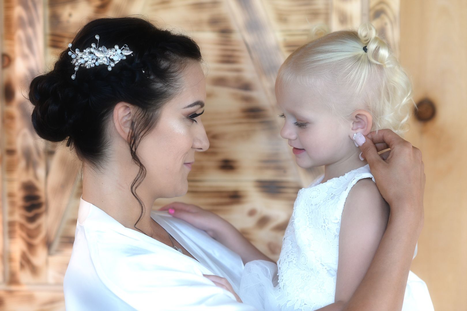 A bride and groom are walking out of an elevator.