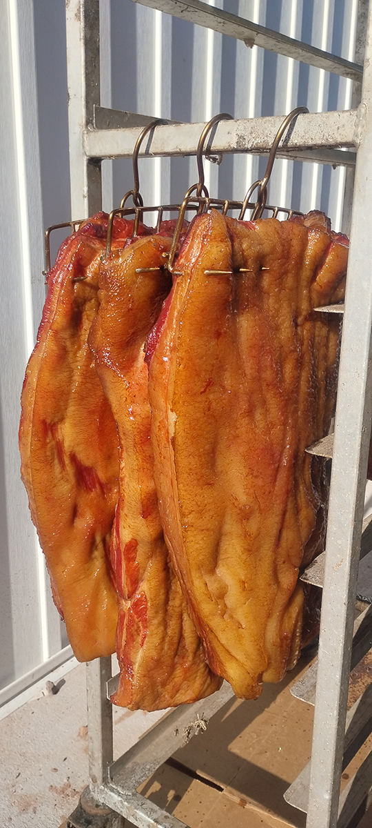 A bunch of meat is hanging on a rack.