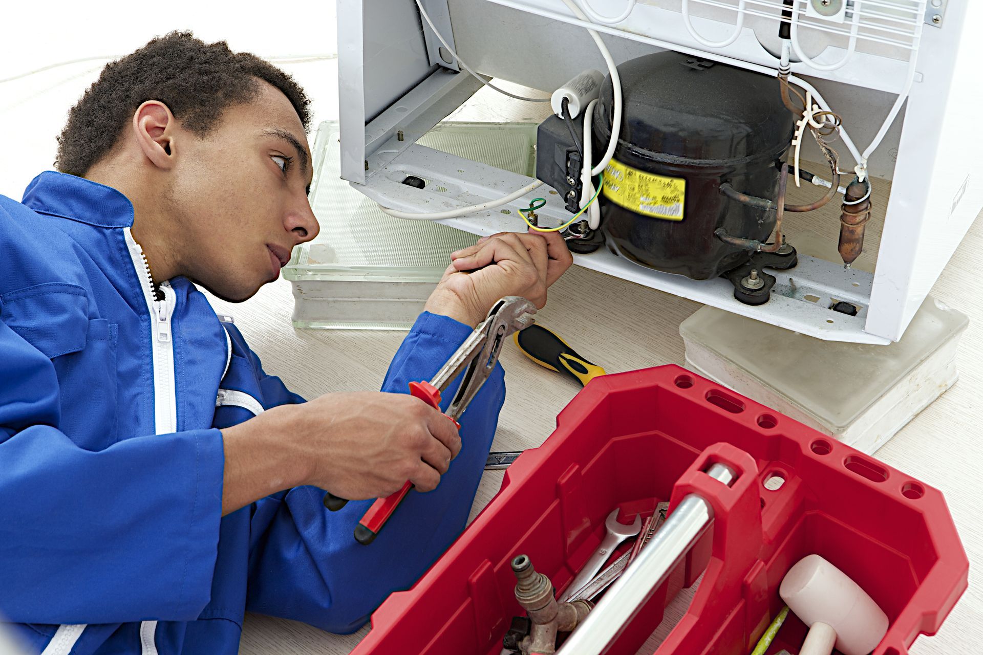 Repair man fixing an appliance