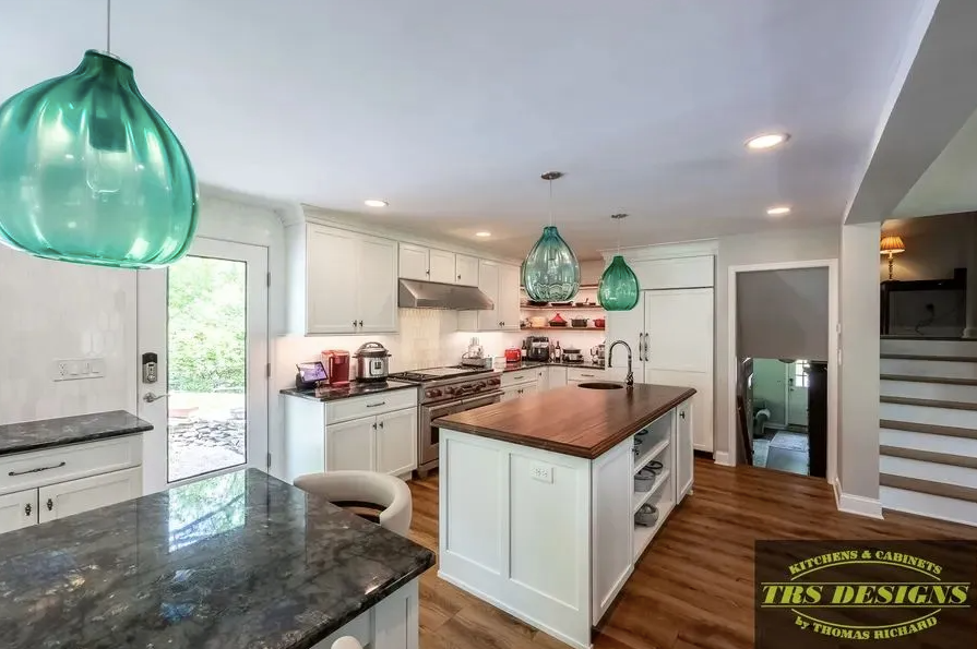 A bathroom with a toilet, sink, mirror and shower.