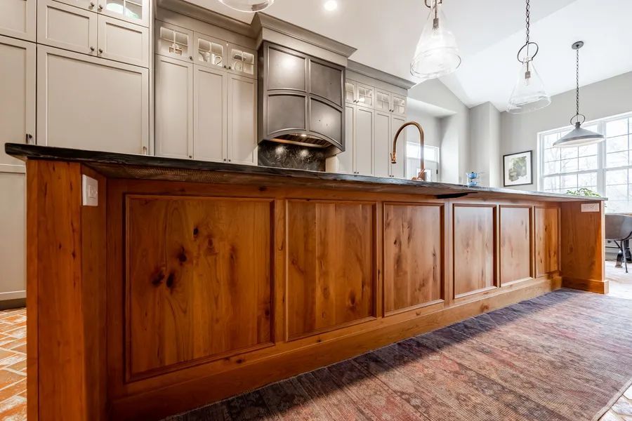 A kitchen with wooden cabinets and a large island.