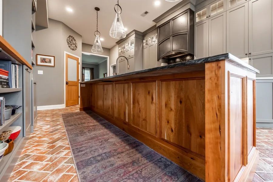A kitchen with wooden cabinets and a large island.
