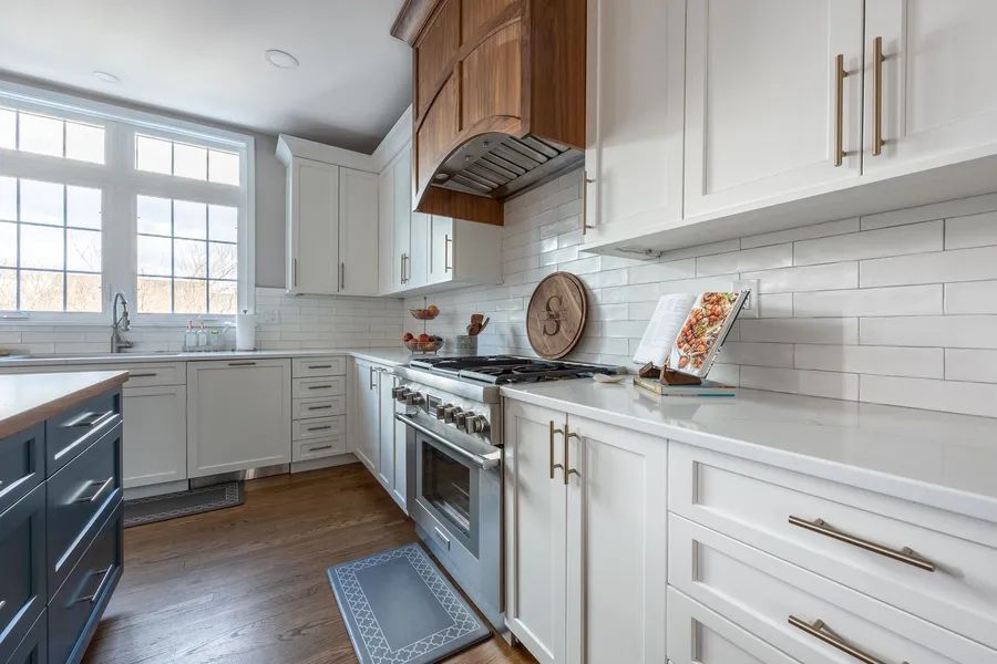 A kitchen with white cabinets and stainless steel appliances.