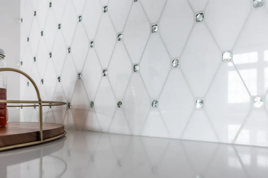 There is a tray on the counter in front of a wall with diamonds on it.