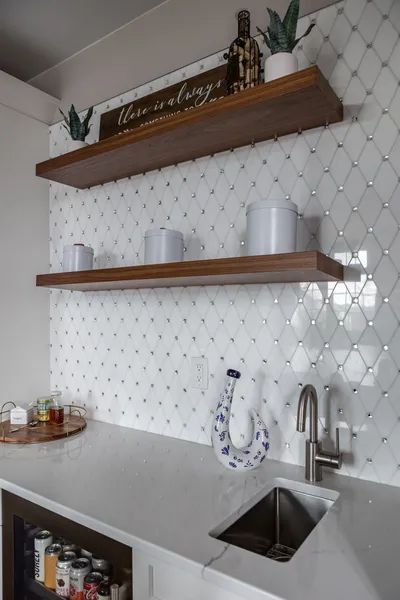 A kitchen with a sink, shelves, and a sign that says always