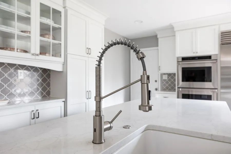 A kitchen with a sink and a faucet on the counter.