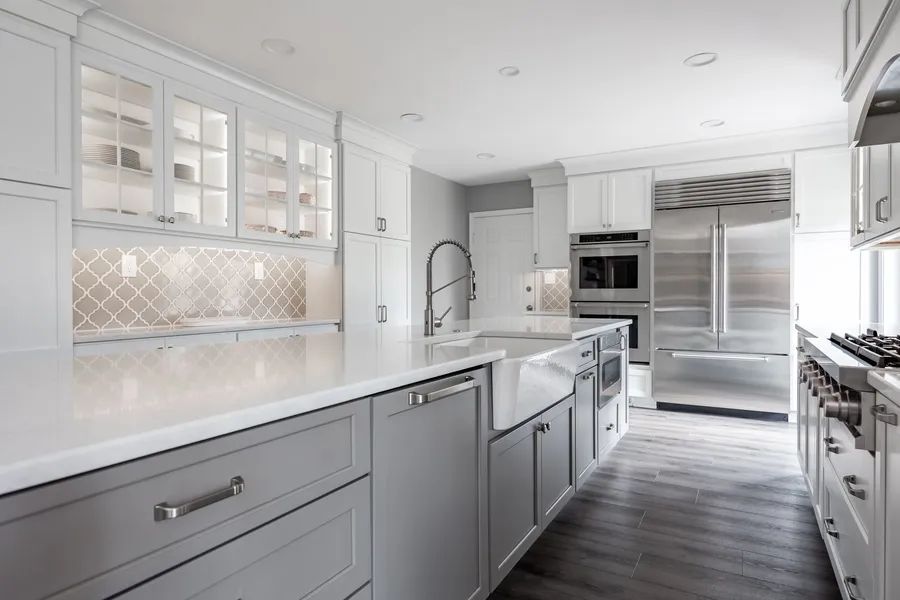 A kitchen with white cabinets and stainless steel appliances.
