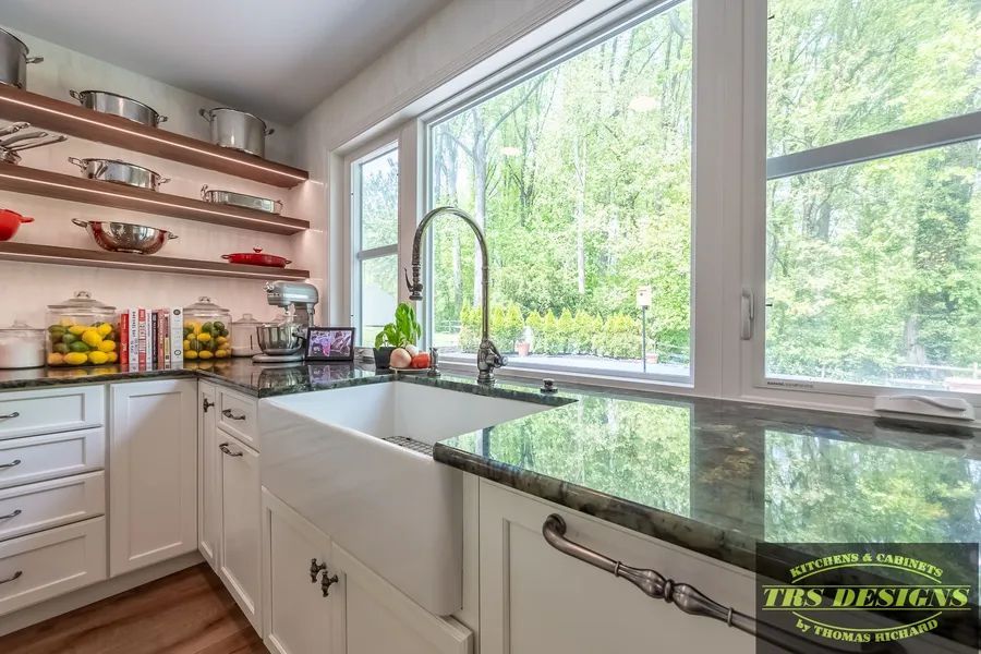 A kitchen with a sink and a large window.