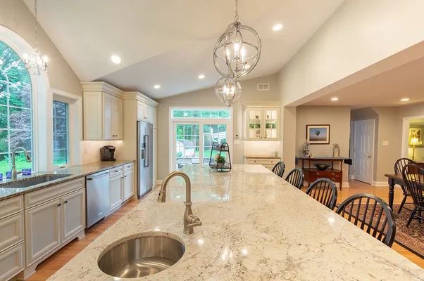 A kitchen with a large island and a sink.