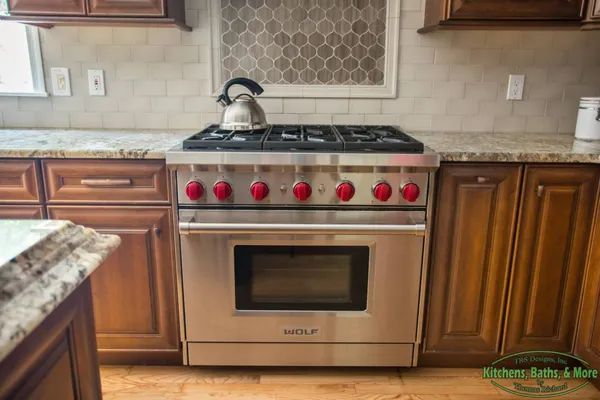 A stove with a kettle on top of it in a kitchen.