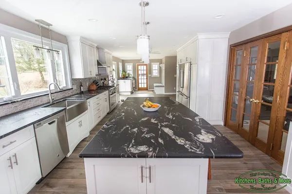 There is a large island in the middle of the kitchen.
