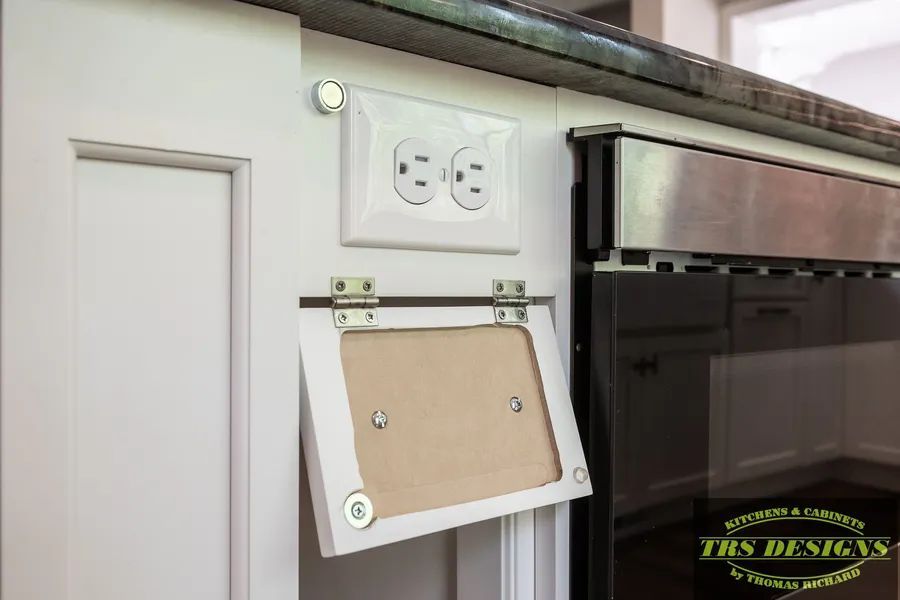 A picture frame is hanging on a wall next to an electrical outlet.