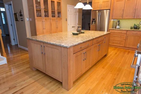 A kitchen with wooden cabinets and granite counter tops