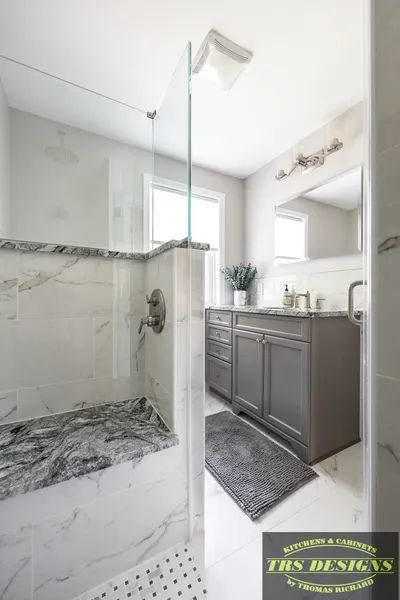A bathroom with a shower and a sink.