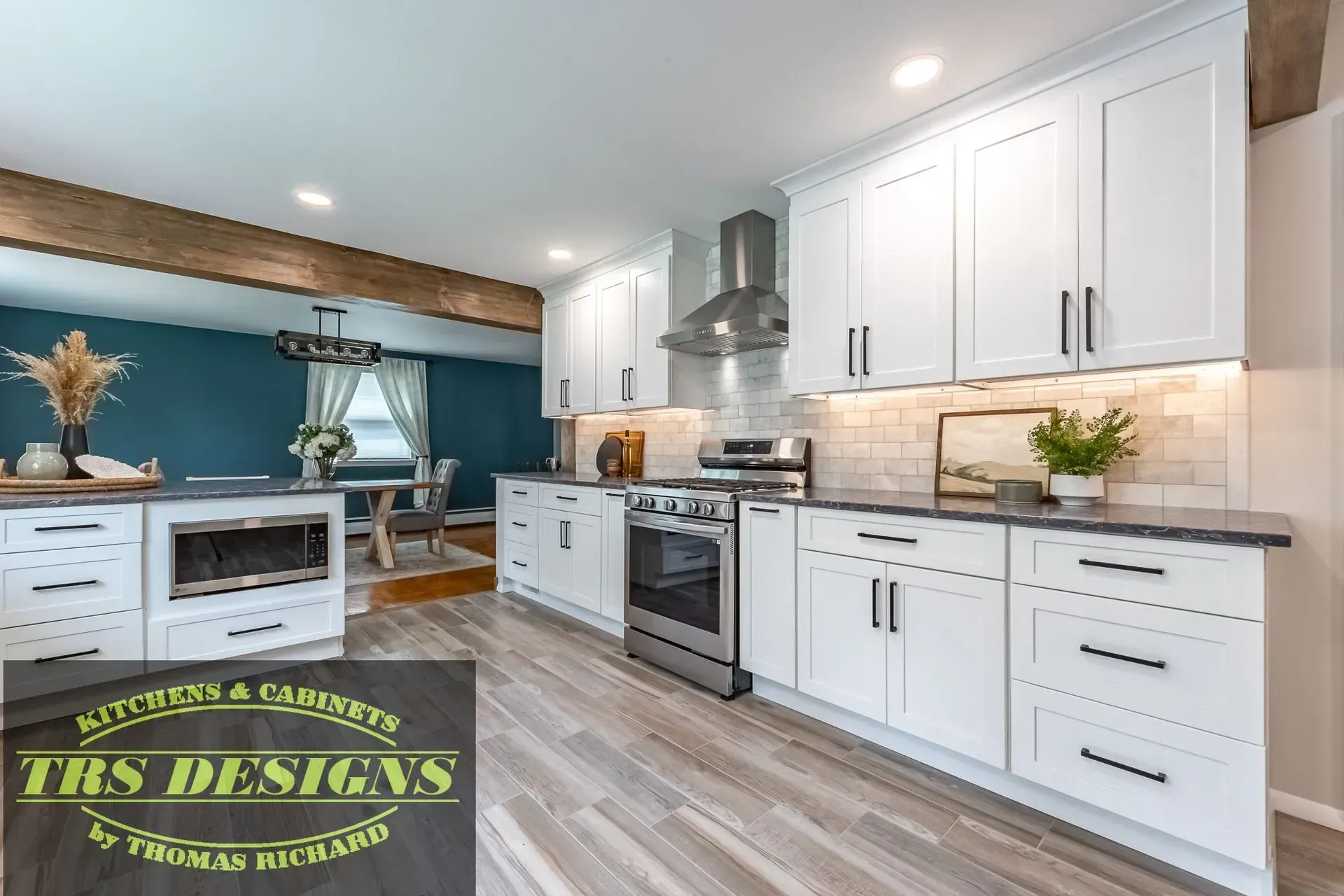 A kitchen with white cabinets and stainless steel appliances.