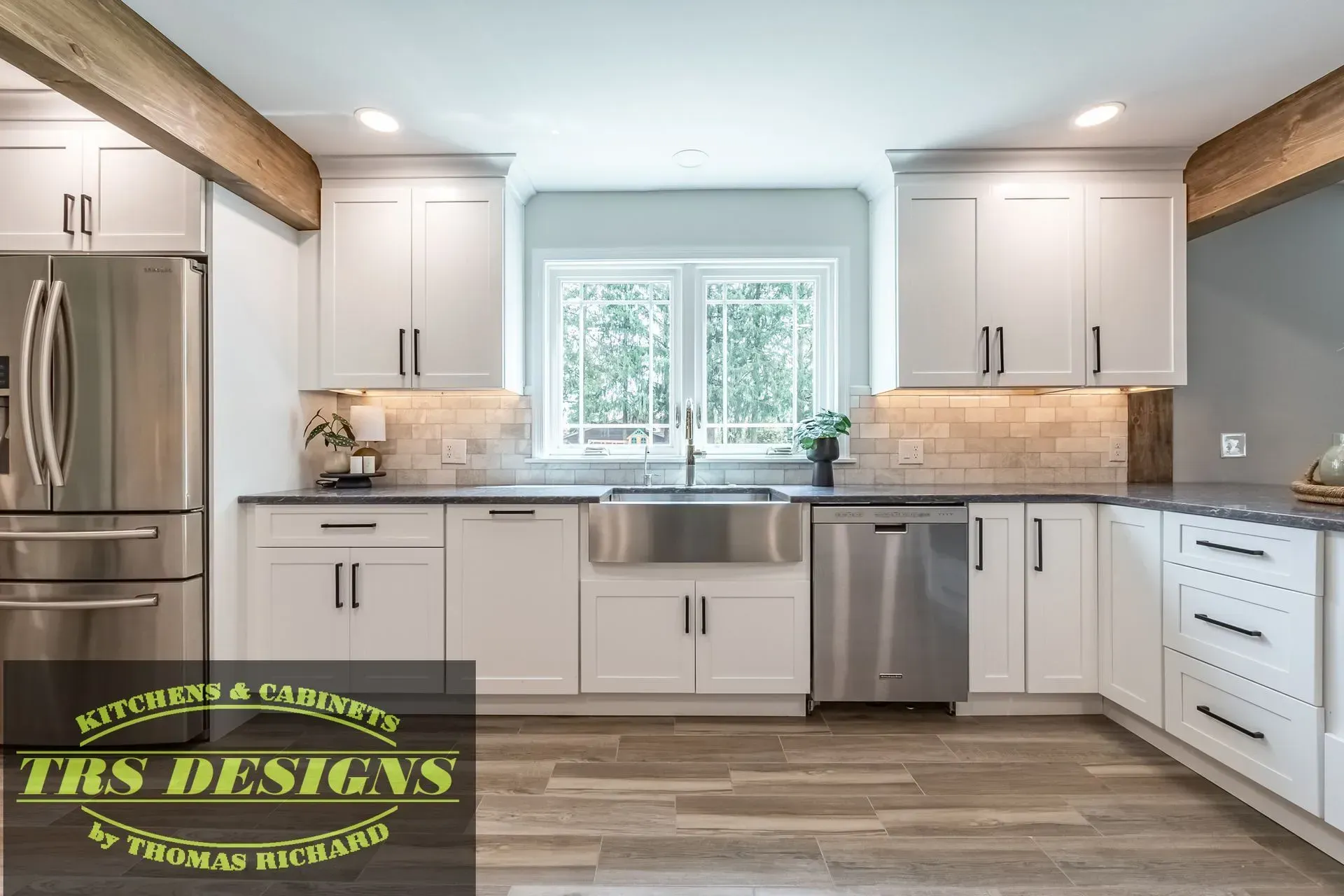 A kitchen with white cabinets and stainless steel appliances.